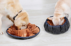 One Golden Retriever, and one French Bulldog eat from a brown Snuffle Truffle Snuffle Mat for Dogs and Cats. The Snuffle Mat turns into a bowl with drawstring for added challenge