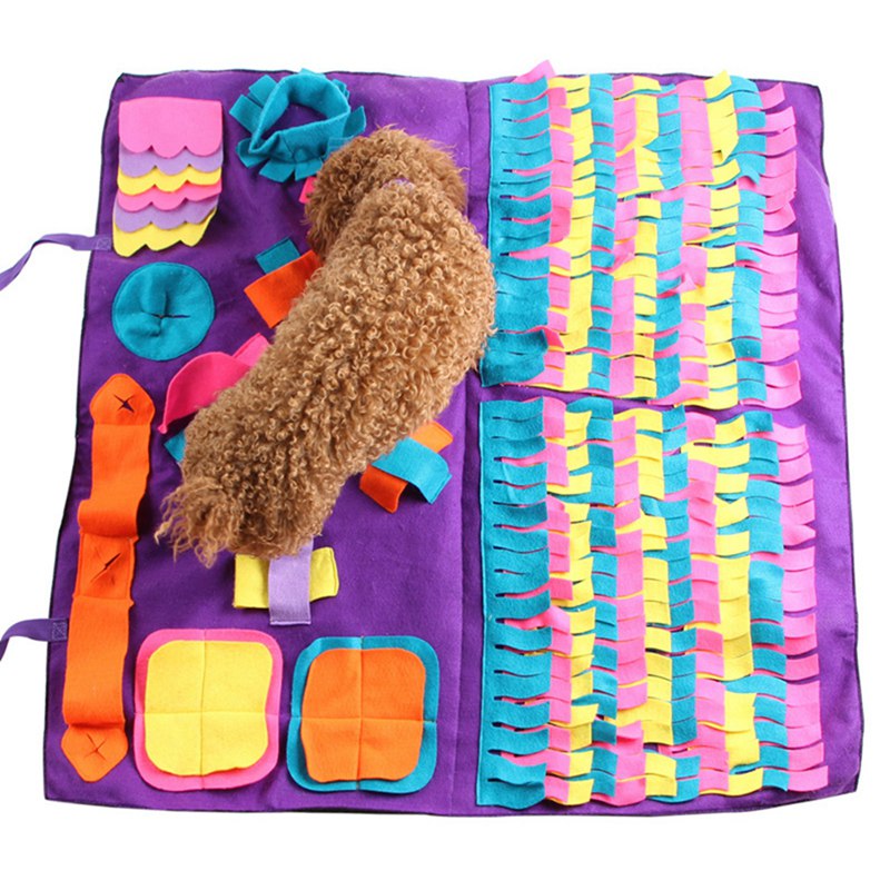 A brown labradoodle hunts for treats on the purple, confetti colored Pinata Frittata snuffle mat 